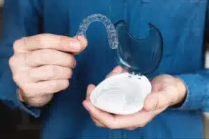 Invisalign aligners and case showing for daily wear time