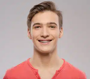 teen smiling with traditional metal braces in Renton WA